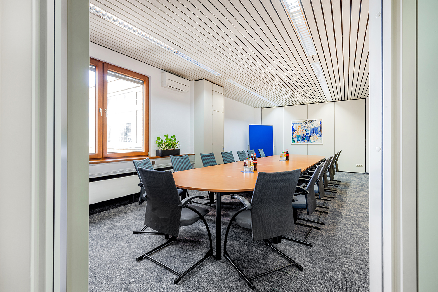 Office+Service-grosser-Konferenzraum Konferenzraum mit langem Holztisch und Bestuhlung