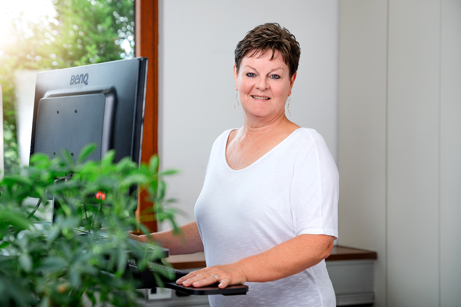 Portrait der Mitarbeiterin Elke Schöniger an ihrem Schreibtisch
